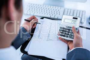 Businessman using his calculator
