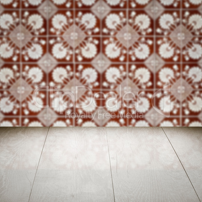 Wood table top and blur vintage ceramic tile pattern wall