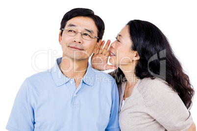 Woman whispering into partners ear