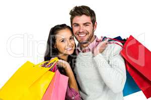 Portrait of smiling couple holding bags