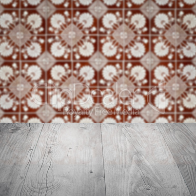 Wood table top and blur vintage ceramic tile pattern wall