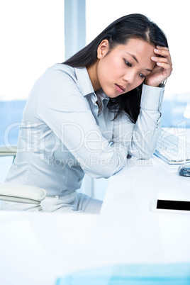 Thoughtful businesswoman with hand on face