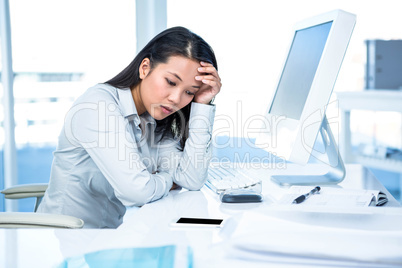 Thoughtful businesswoman with hand on face