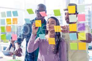 Business people discussing over adhesive notes