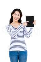 Cheerful woman pointing at tablet computer