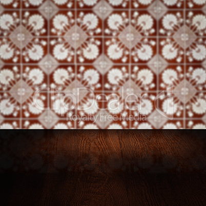 Wood table top and blur vintage ceramic tile pattern wall