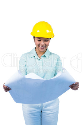 Architect reading a plan with yellow helmet