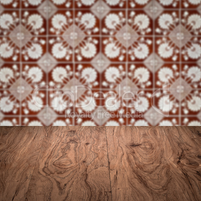 Wood table top and blur vintage ceramic tile pattern wall