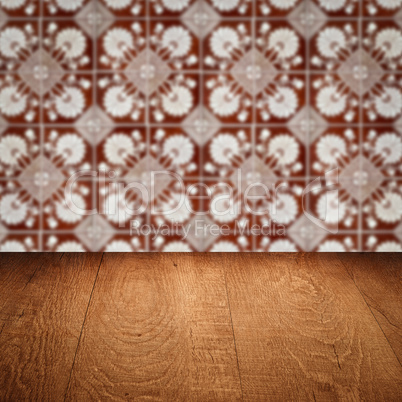 Wood table top and blur vintage ceramic tile pattern wall