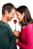 Happy couple holding red rose