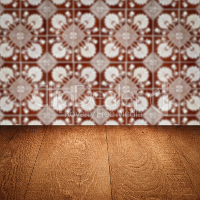 Wood table top and blur vintage ceramic tile pattern wall
