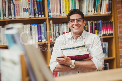 Portrait of smiling nerd holding books