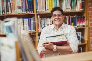 Portrait of smiling nerd holding books