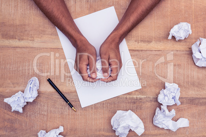 Overhead view of businessman making paper balls