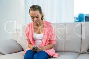 Smiling woman using smartphone