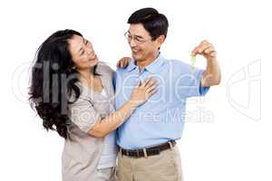 Smiling couple holding a set of keys