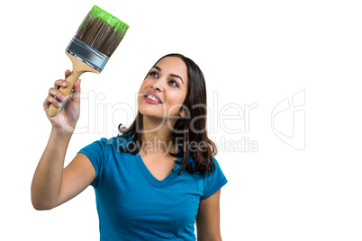 Smiling woman holding paint brush