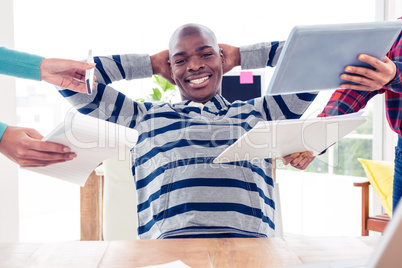 Portrait of businessman relaxing in office