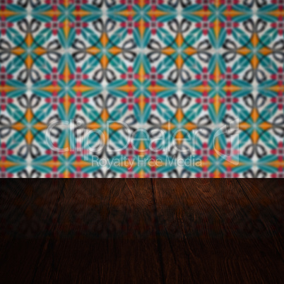 Wood table top and blur vintage ceramic tile pattern wall