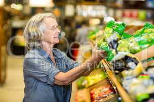 Senior woman buying vegetables