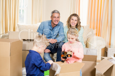 Cute family opening boxes