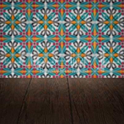 Wood table top and blur vintage ceramic tile pattern wall Wood table top and blur vintage ceramic tile pattern wall