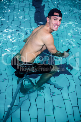 Fit man cycling in the pool