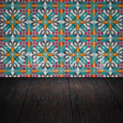 Wood table top and blur vintage ceramic tile pattern wall Wood table top and blur vintage ceramic tile pattern wall