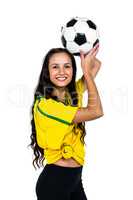 Smart supporting woman holding football