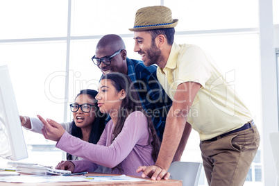 Businesswomen explaining colleagues over computer