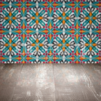 Wood table top and blur vintage ceramic tile pattern wall Wood table top and blur vintage ceramic tile pattern wall