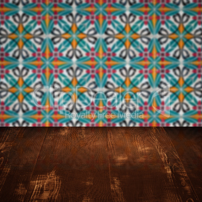 Wood table top and blur vintage ceramic tile pattern wall