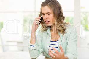 Frowning woman having phone call