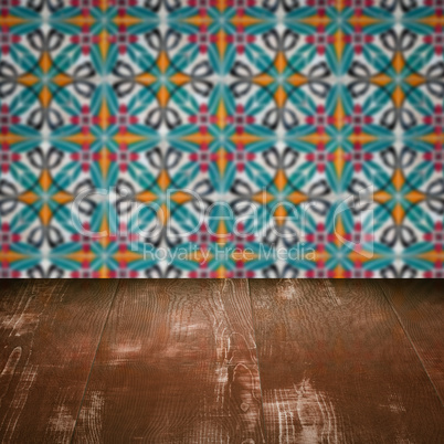 Wood table top and blur vintage ceramic tile pattern wall