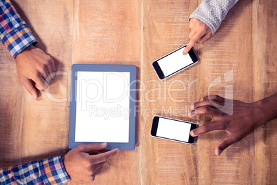 Cropped image of hands using mobile phone and tablet PC