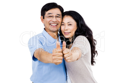 Smiling couple with thumbs up