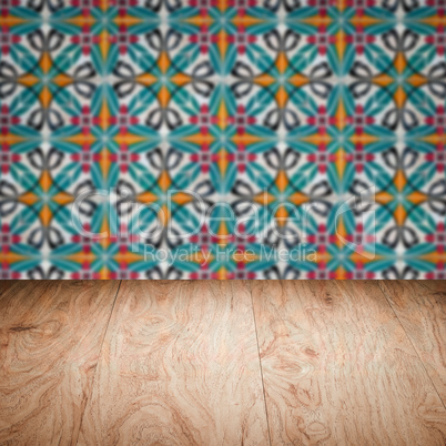 Wood table top and blur vintage ceramic tile pattern wall