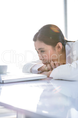 Serious woman leaning her chin on her hands