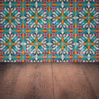 Wood table top and blur vintage ceramic tile pattern wall