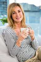 Smiling woman holding a cup