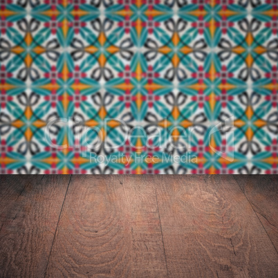 Wood table top and blur vintage ceramic tile pattern wall