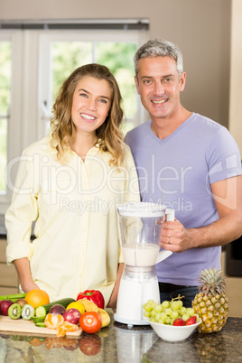 Smiling couple preparing healthy smoothie