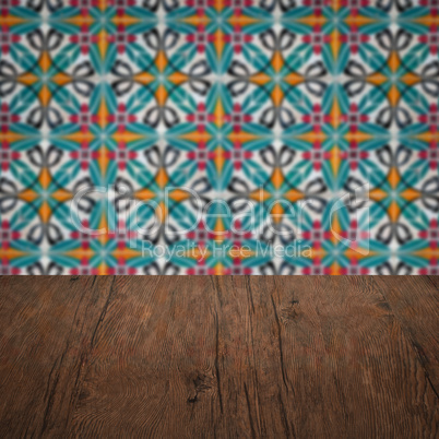 Wood table top and blur vintage ceramic tile pattern wall