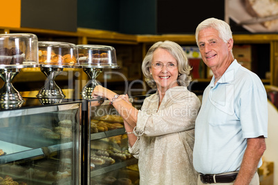 Senior couple pointing puddings