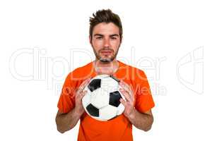 Handsome supporter holding football ball
