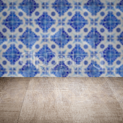 Wood table top and blur vintage ceramic tile pattern wall