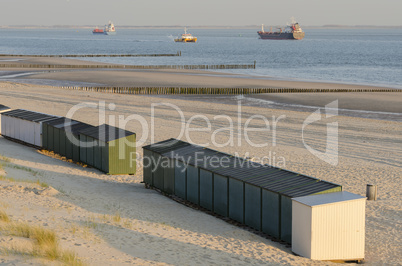 Beach huts on a beach in Zeeland .