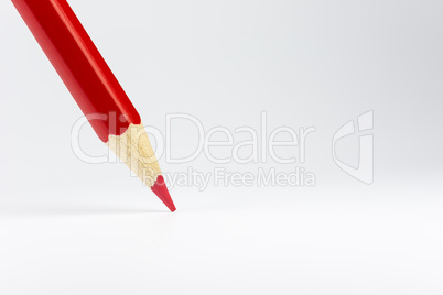 Standing red colored pencil on a white background.