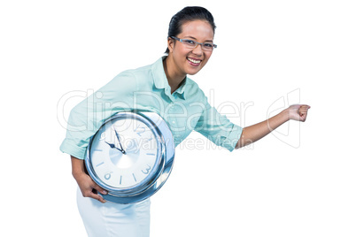 Delighted businesswoman holding a clock