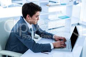 Serious asian businessman using his computer